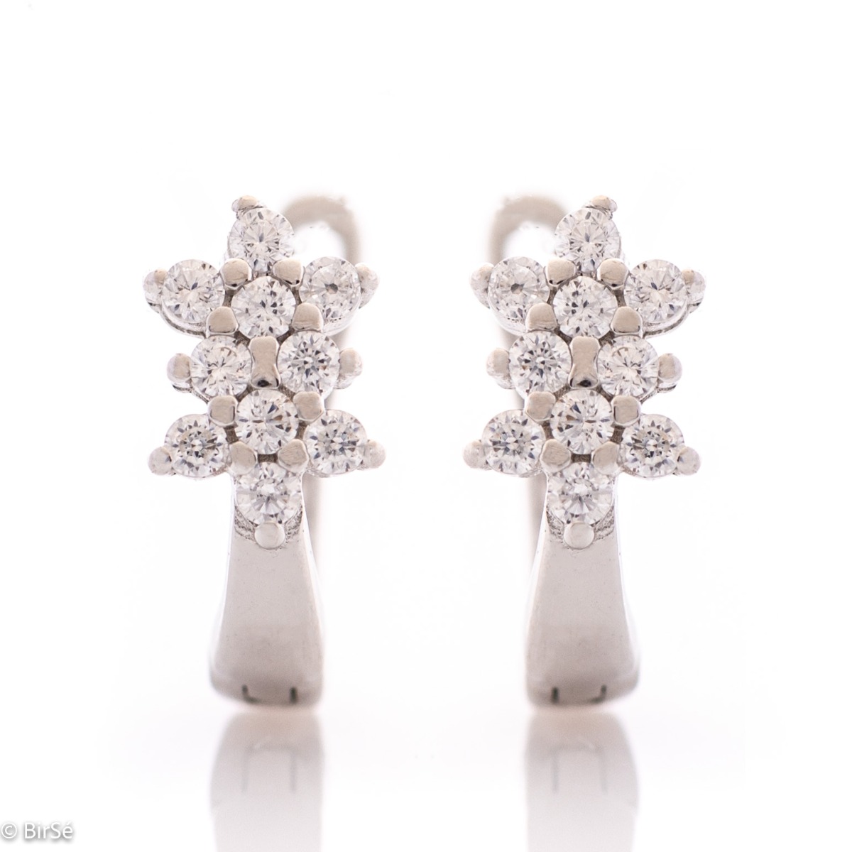 Charming ladies earrings made of rhodium silver with a comfortable English clasp. The front side of the earrings is in the shape of exquisite flowers, carefully crafted from zircons.