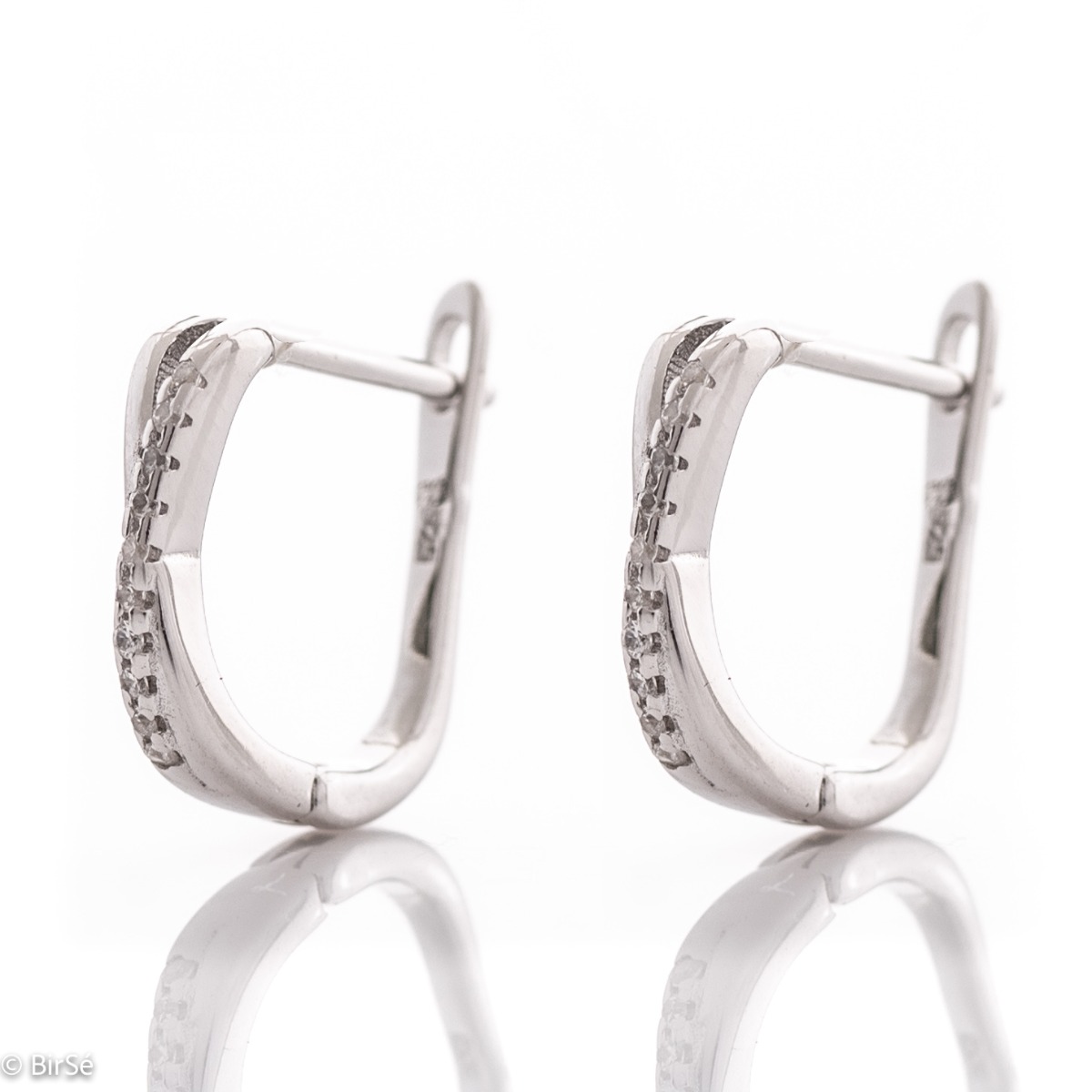 Elegant women's earrings made of rhodium-plated fine silver. The earrings are decorated with delicate zircons, with a stylish design and a comfortable English clasp. A wonderful gift for your beloved woman.