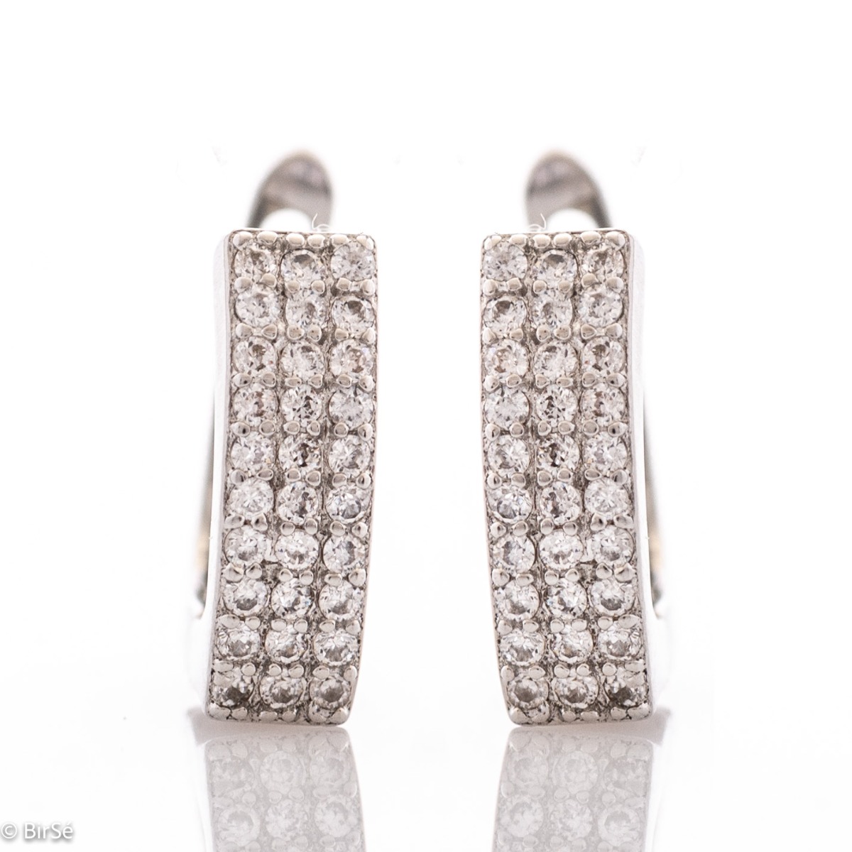 Captivating women's earrings with a spectacular shape and modern design. Crafted entirely from rhodium-plated sterling silver, with a comfortable English clasp and added dazzling zircons, they are the perfect piece of jewelery for any outfit.