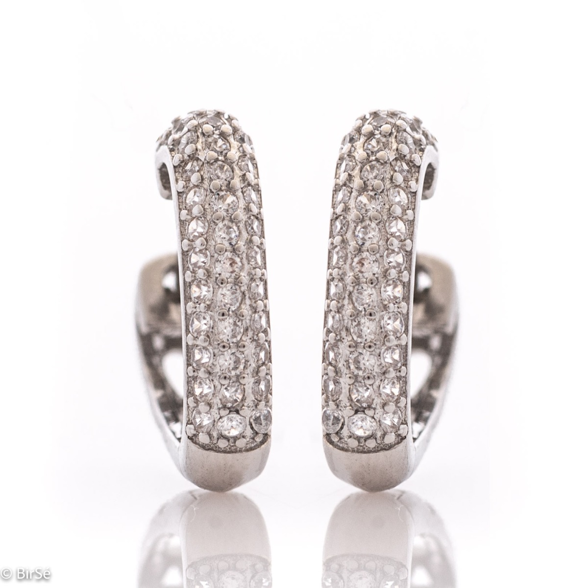 Elegant sterling silver earrings with an English clasp and precision craftsmanship entirely from soft rhodium-plated silver combined with fine, sparkling zircons.