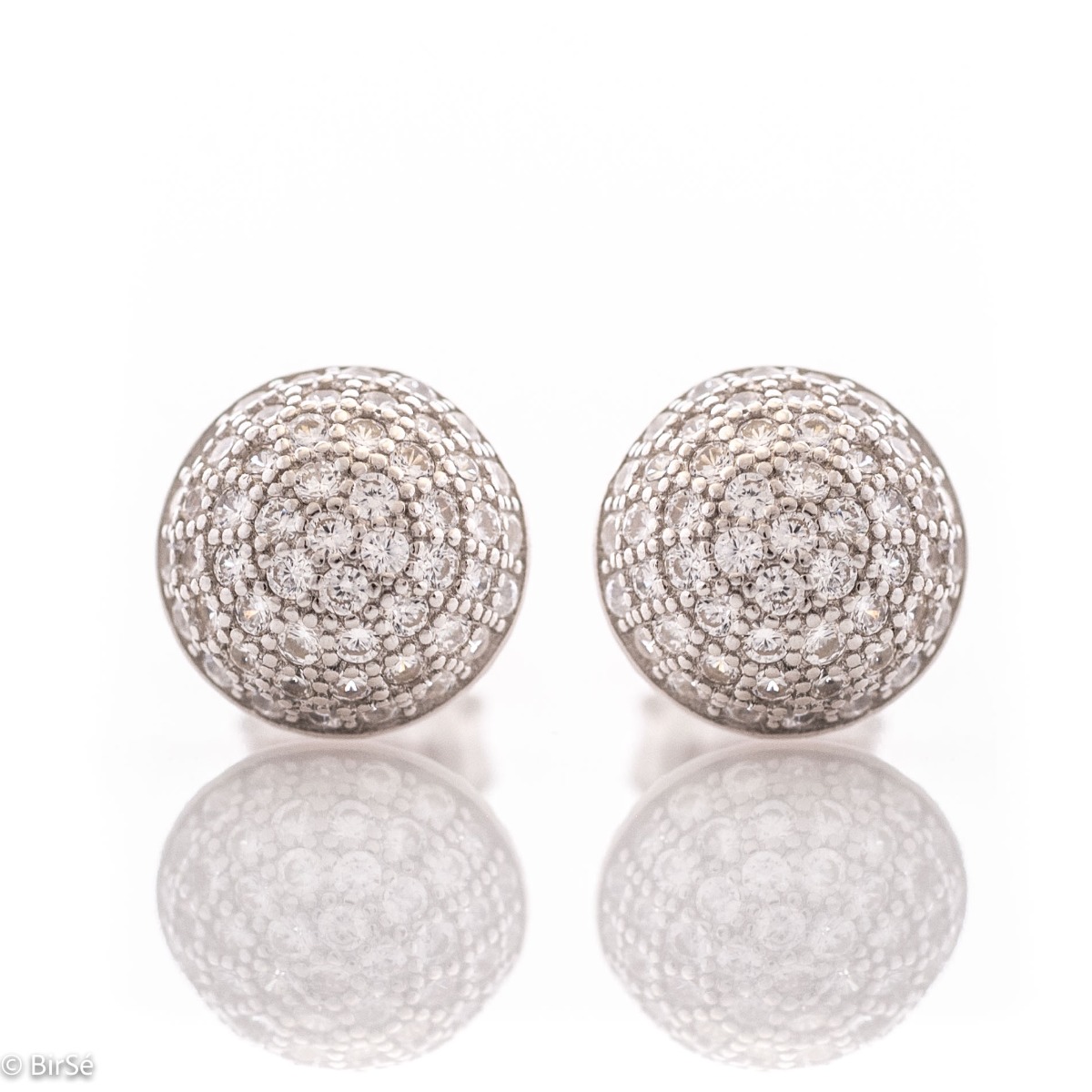 Charming women's earrings, masterfully crafted from fine rhodium silver with an elegant design. A beautifully sculpted hemisphere, dazzling zircons magically sparkle on silver, and the pin fastening is comfortable and practical.