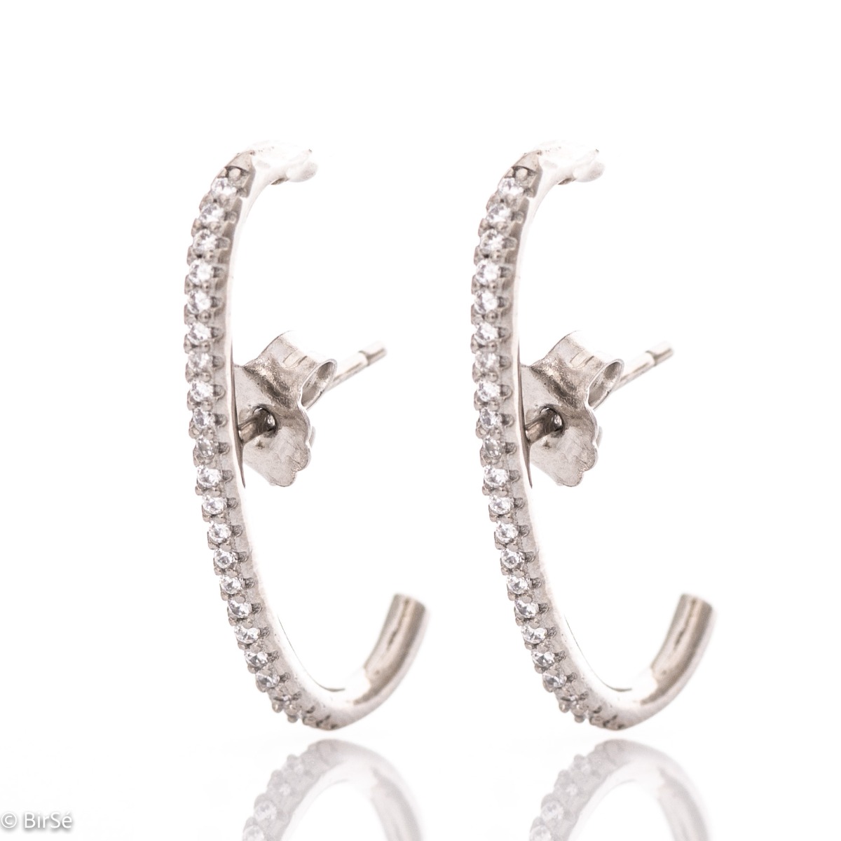 Non-standard earrings in fine rhodium silver with a modern design, decorated with sparkling zircons. Fastening with a pin - practical and comfortable.