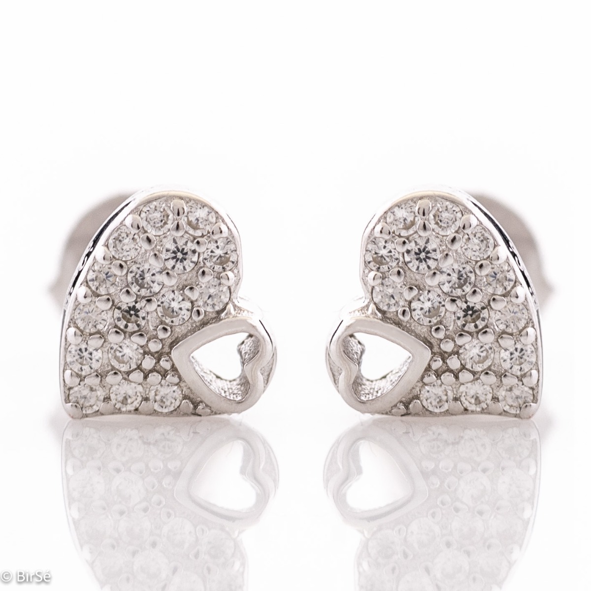 Elegant silver earrings in the shape of delicate hearts, beautifully fused into each other. Stylish workmanship of the composite compositional elements from a fine combination of rhodium-plated silver with sparkling zircon stones.