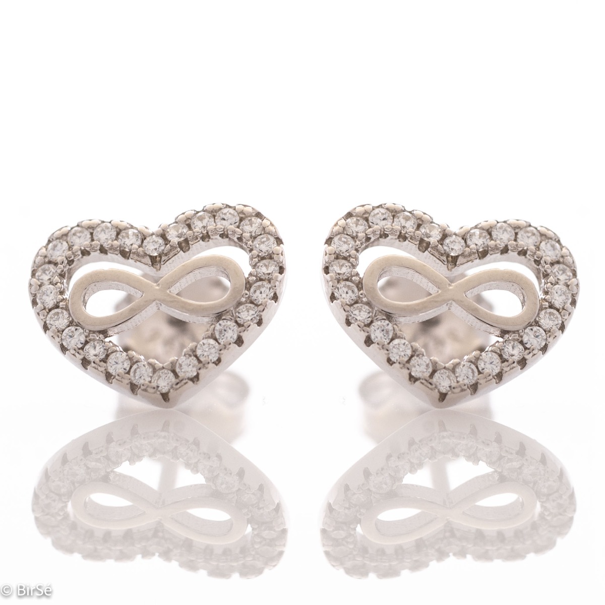 Captivating women's infinity heart earrings. They are made entirely of rhodium-plated silver and have a convenient pin fastening. They can be combined with a pendant of the same model. Encrusted with sparkling zircons, these earrings make a wonderful gift