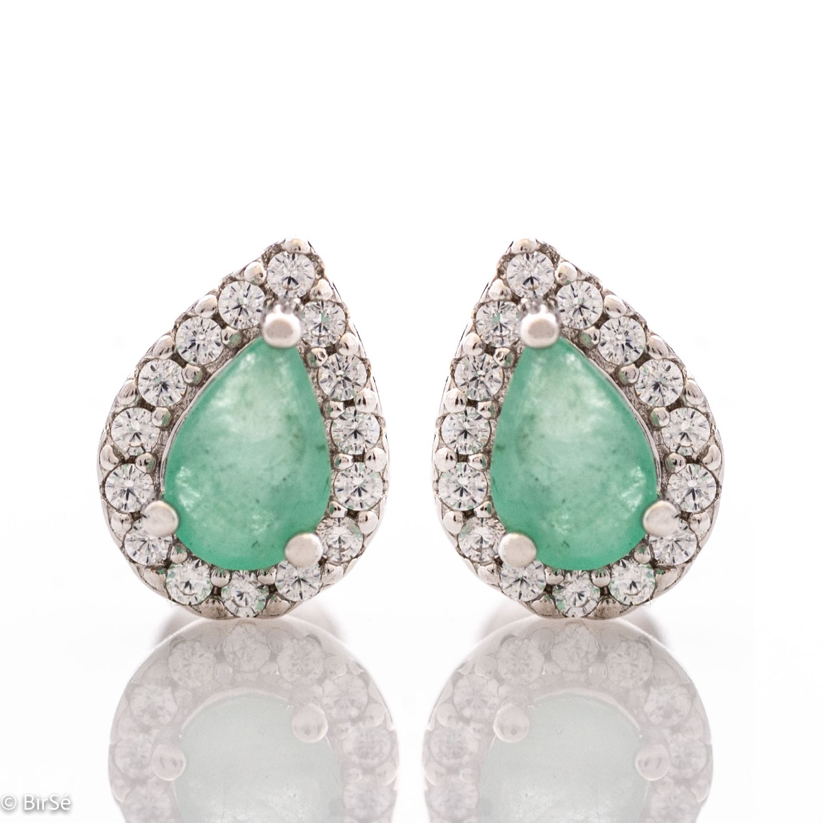 Radiant stud earrings delicately crafted in teardrop shape and fine rhodium silver, complemented by exquisite natural emerald and sparkling zircons.