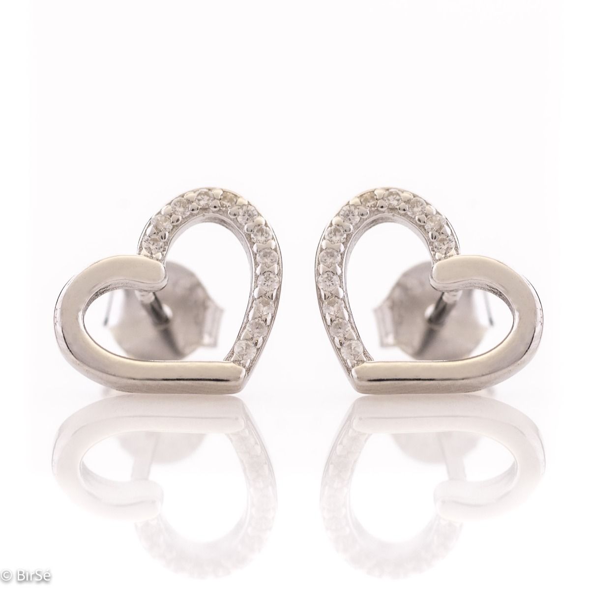 Beautiful and simple heart earrings made of rhodium silver, elegantly decorated with zircons. Screw fastening for convenience and security. They allow to be combined with silver jewelry with zircons.