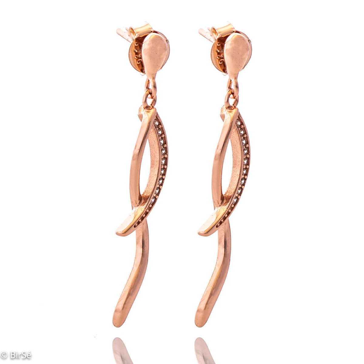 Charming women's dangle earrings made entirely of soft rose silver with exquisitely shaped curves, embellished with dazzling cubic zirconias. Fastening with a pin is for more convenience and comfort.