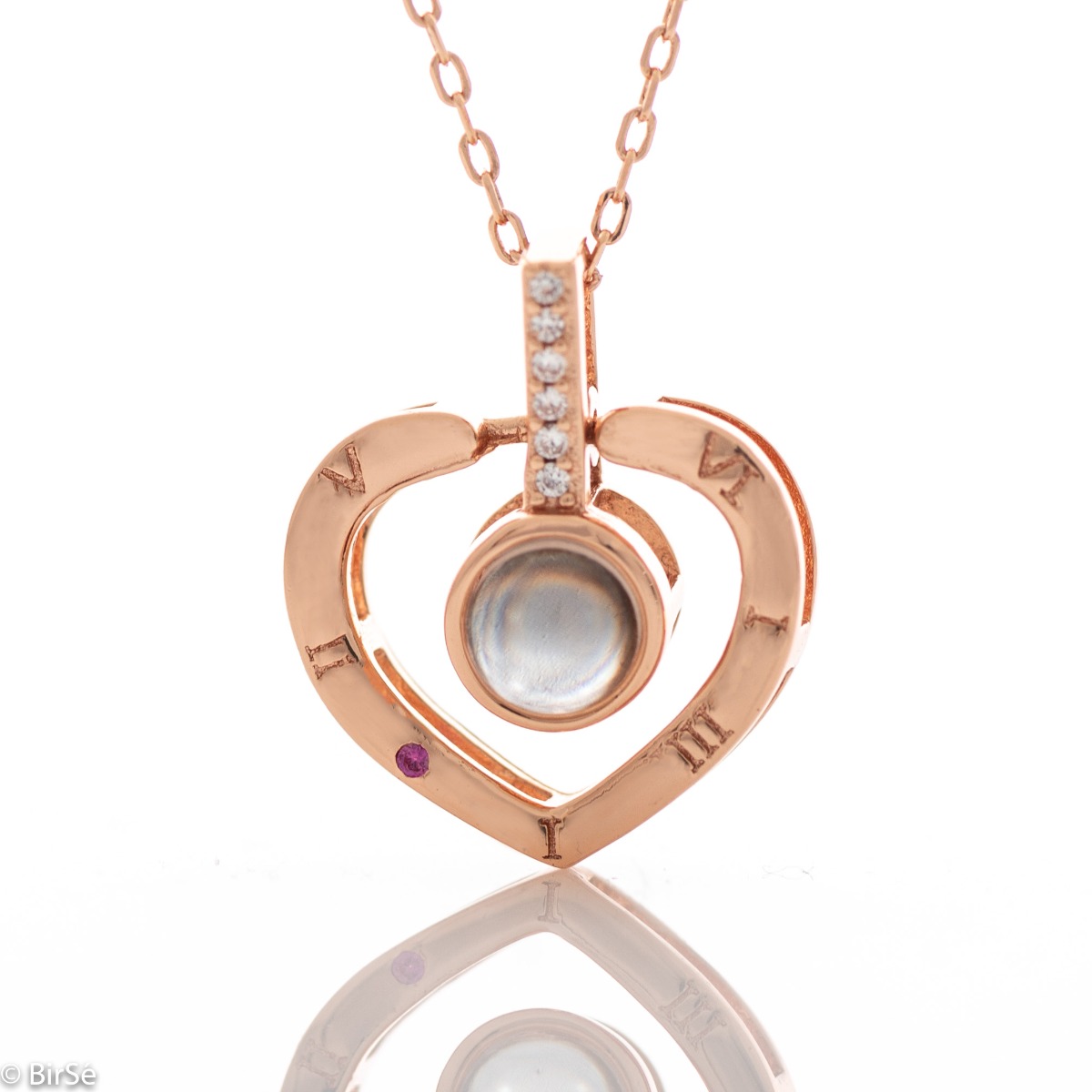 Delightful craftsmanship of rose silver heart shaped necklace. A unique stone adorns the center of the heart and upon its illumination, the magic of love will wash over you in 100 languages. There is no better way to say "I love you" x 100.