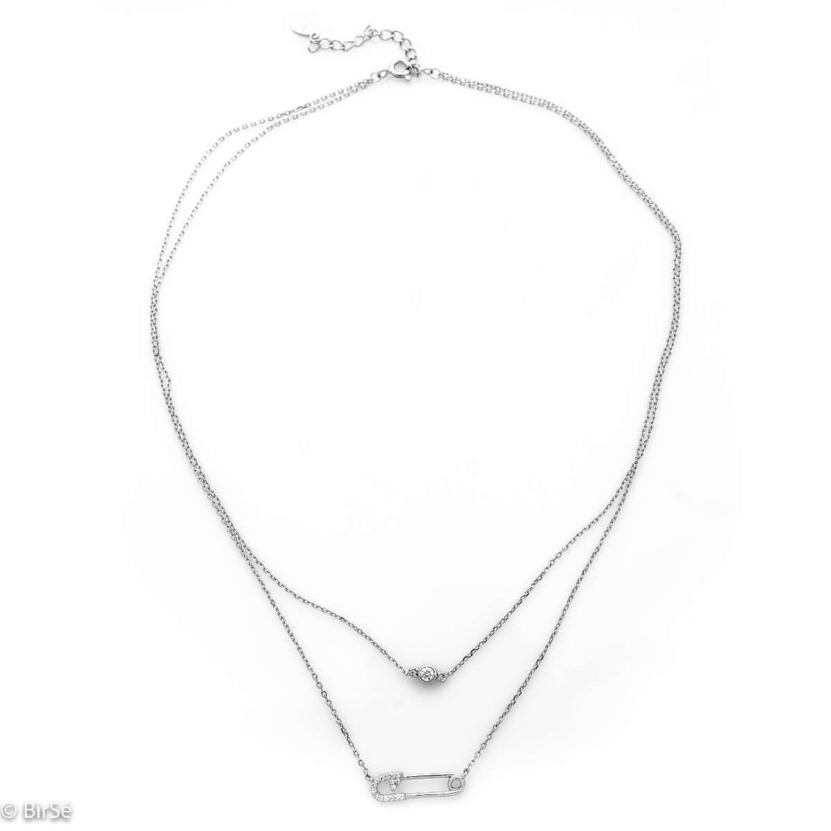 Elegant and trendy sterling silver necklace in the shape of a safety pin encrusted with zircons. There is a small fine zircon on the second, shorter chain of the necklace.