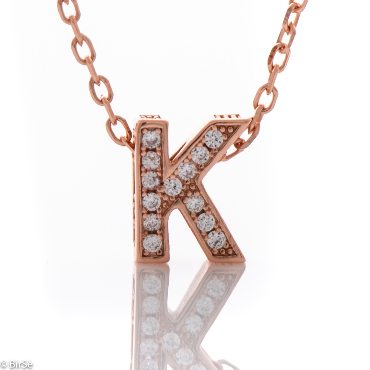 Finely crafted rose silver letter K necklace for women, all encrusted with glittering zircons. An attractive piece of jewelry in which the delicate beauty of rose silver is skilfully combined with the brilliance of zircons.