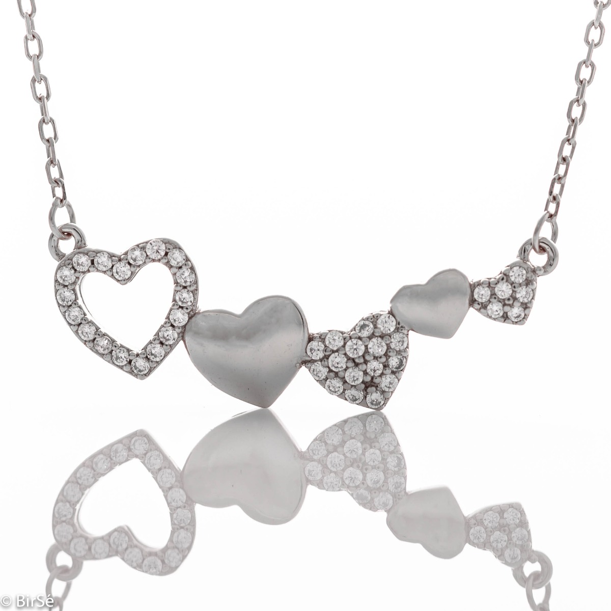 Spectacular and beautiful women's necklace - a row of several tender hearts. Made entirely of sparkling rhodium silver with countless beautiful cubic zirconias.