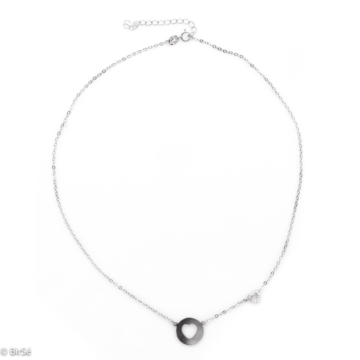 Modern women's necklace made of soft silver with a round plate and a heart cut into it. As an addition, a small heart pendant with zircons is attached to the top of the chain.