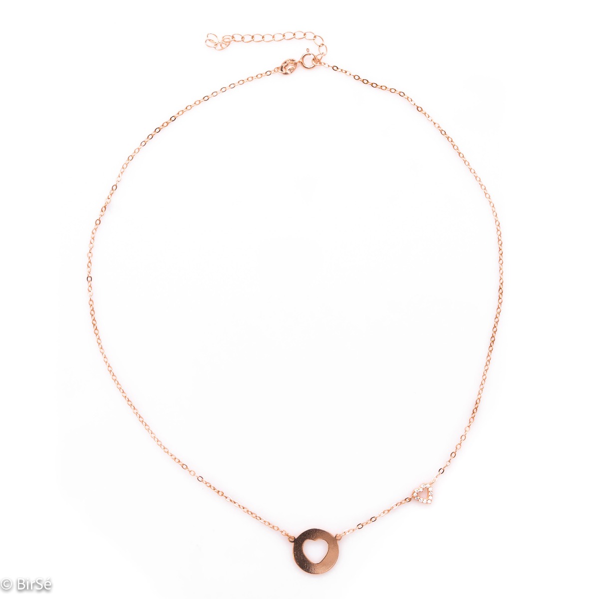 Modern women's necklace in soft rose silver with a round plate and a heart cut into it. As an addition, a small heart pendant with zircons is attached to the top of the chain.