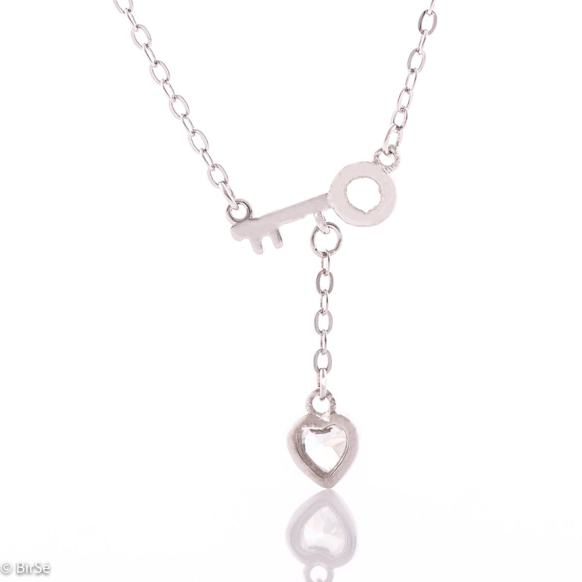 Elegant silver message necklace. A dainty rhodium-plated chain is attached to a dainty key with a cubic zirconia heart hanging below. Discover the key to the heart of the beloved woman with the charming necklace from BirSe.