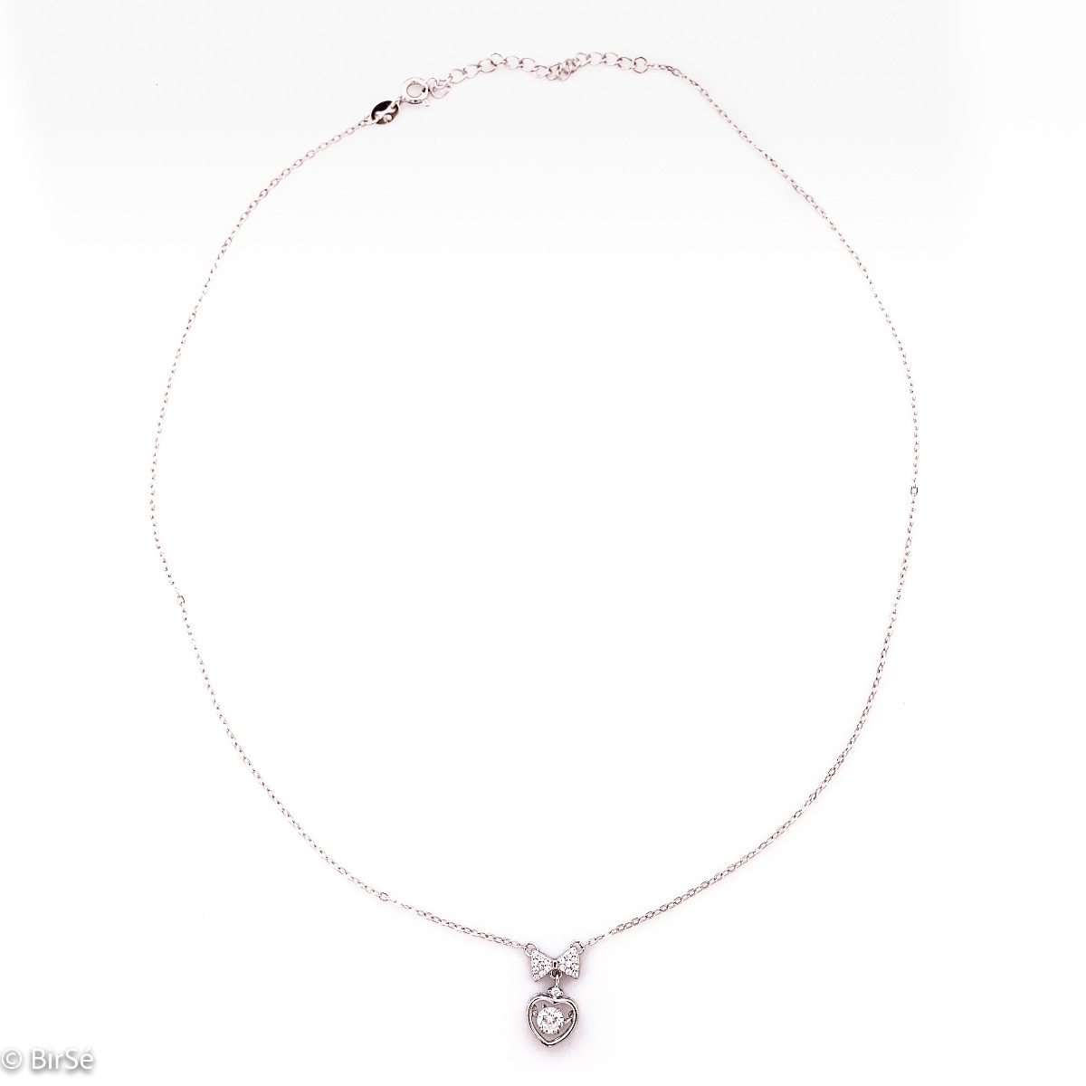 A stylish women's necklace made of glittering rhodium silver with an elegant heart-shaped pendant, in the center of which a dazzling zircon mystically sparkles. The pendant is attached with an elegant ribbon, fully decorated with zircons.