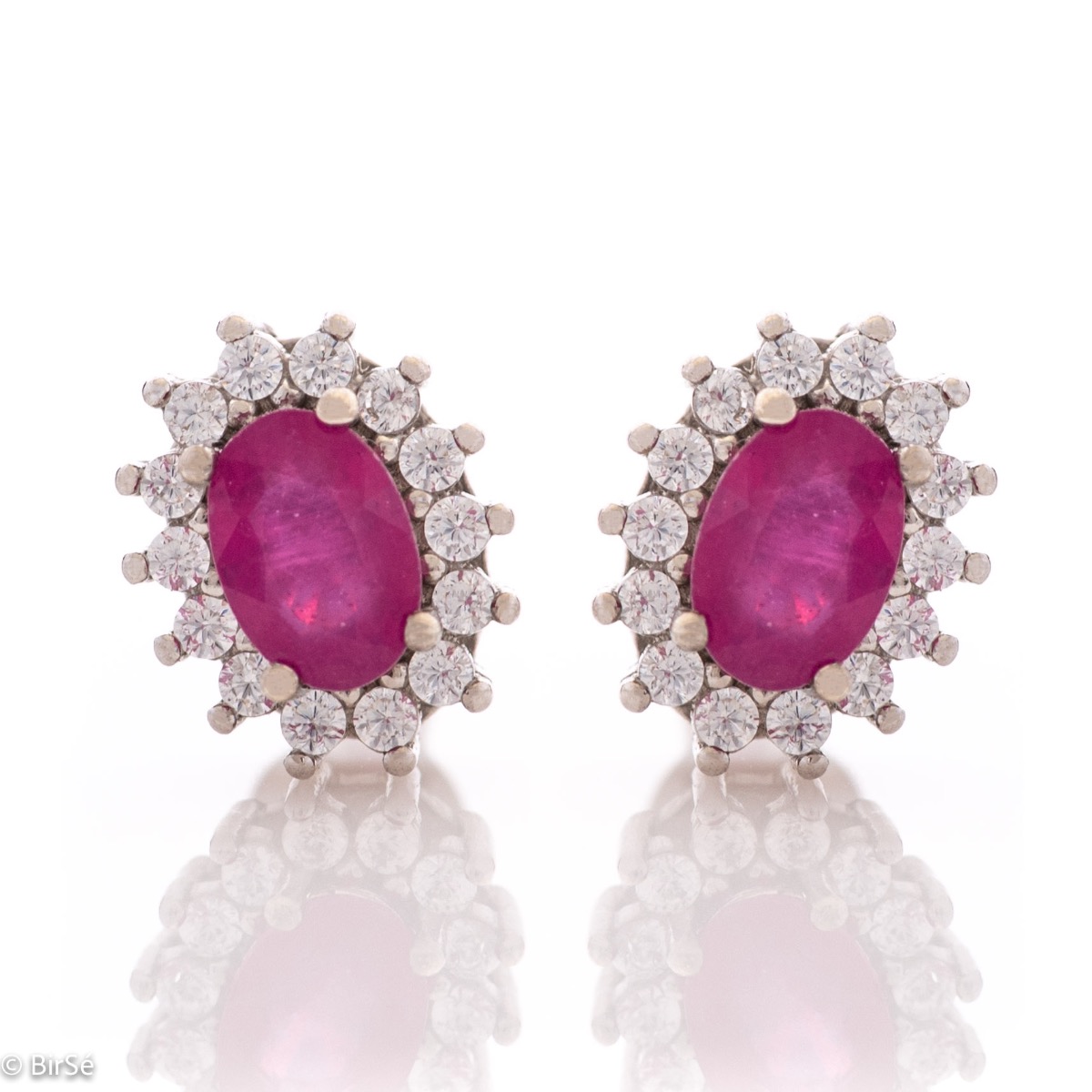 Delicate and radiant women's stud earrings with exquisite workmanship combining a unique natural ruby, surrounded by sparkling zircons, with rhodium-plated silver. They can be combined with a ring, necklace and bracelet of the same model.