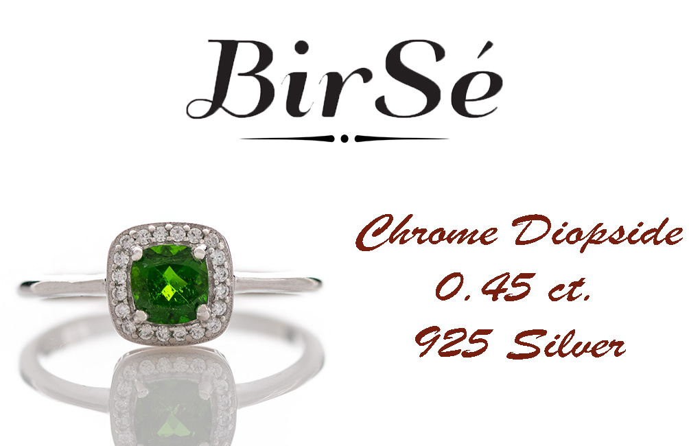 An elegant ring with precise craftsmanship from soft rhodium-plated silver. At the center of the jewel is set a mesmerizing green Chrome Diopside stone in the company of sparkling zircons. Part of a sophisticated set including a pendant and stud earrings.