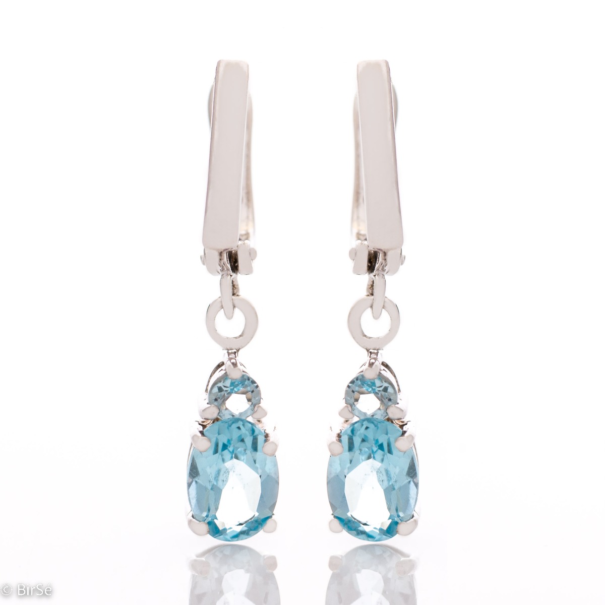 Elegant rhodium silver dangle earrings for every style - these are our earrings with a captivatingly delicate blue topaz. Elegance yourself or a loved one with the complete set, which includes a ring and pendant with the same lovely design.