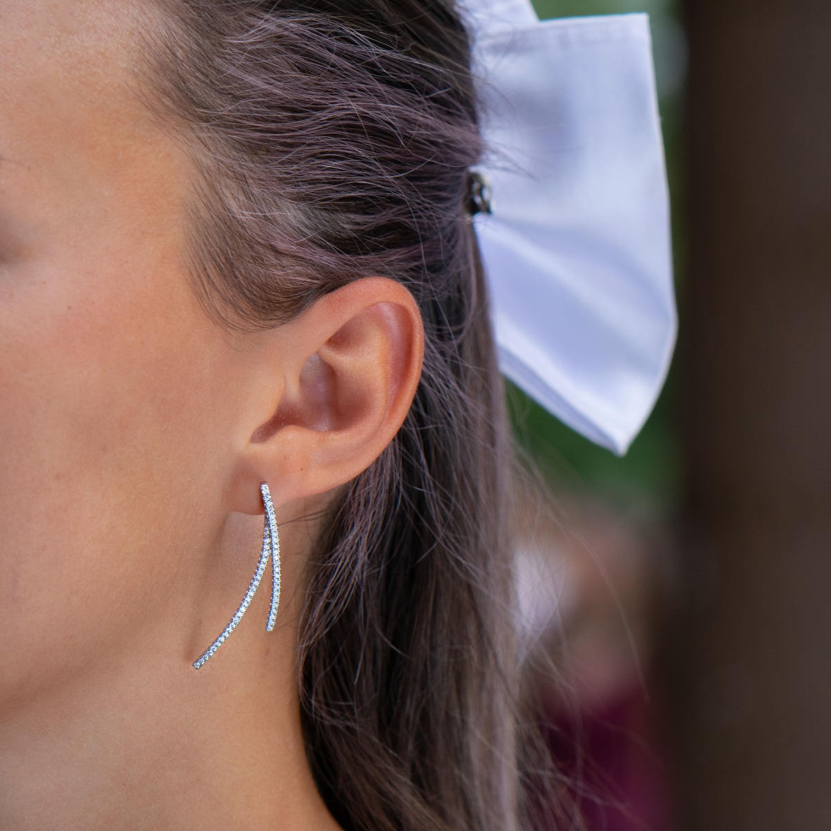 Feminine and tempting earrings cast from rhodium silver with captivating zircons adorning the spectacular jewel. The look of delicate earrings has an interesting design solution. The fastening is with a pin, for greater convenience and comfort.