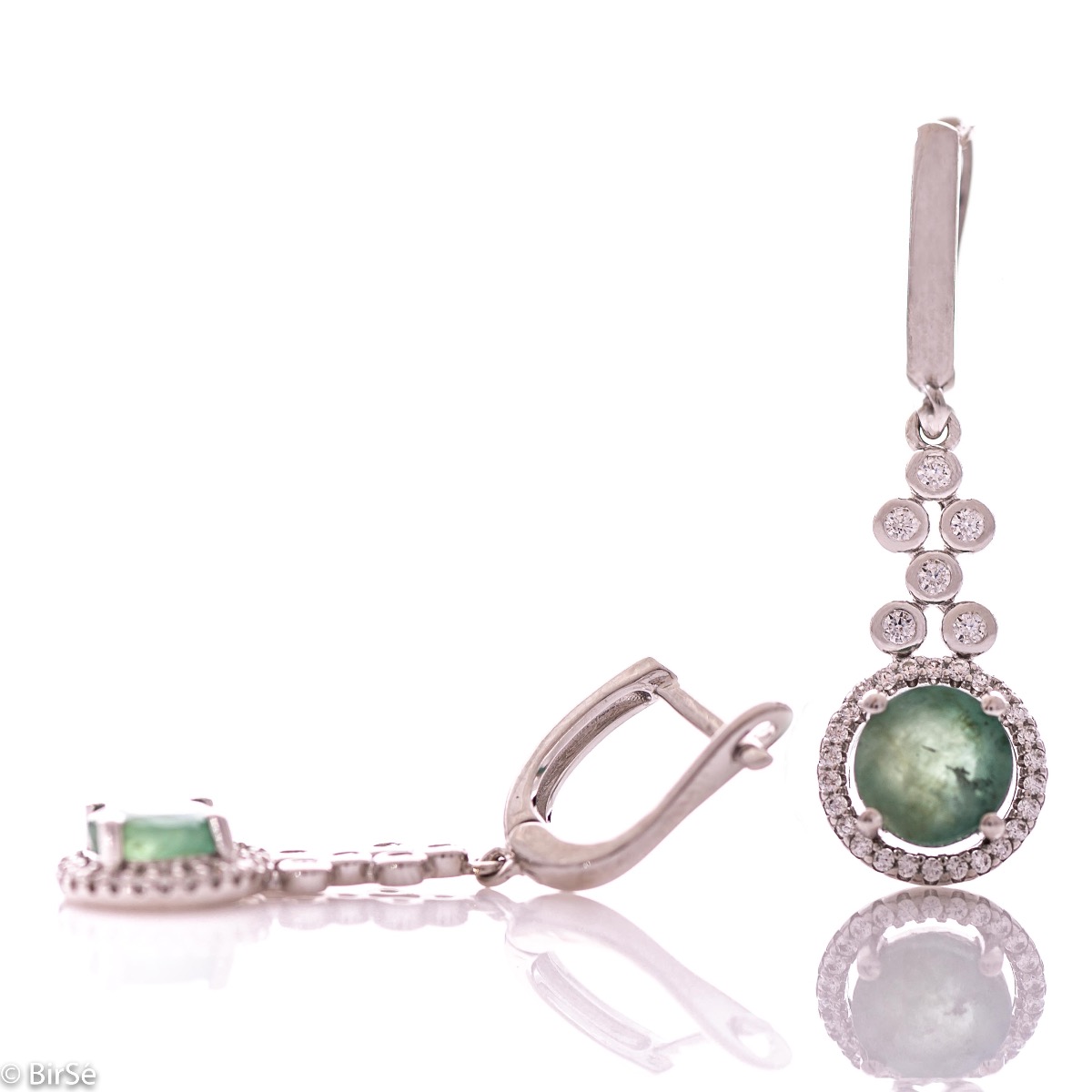 Women's dangling earrings with English clasp and precision craftsmanship entirely in rhodium-plated silver, combined with a radiant natural emerald and sparkling zircons. They can be combined with a ring and pendant of the same model.