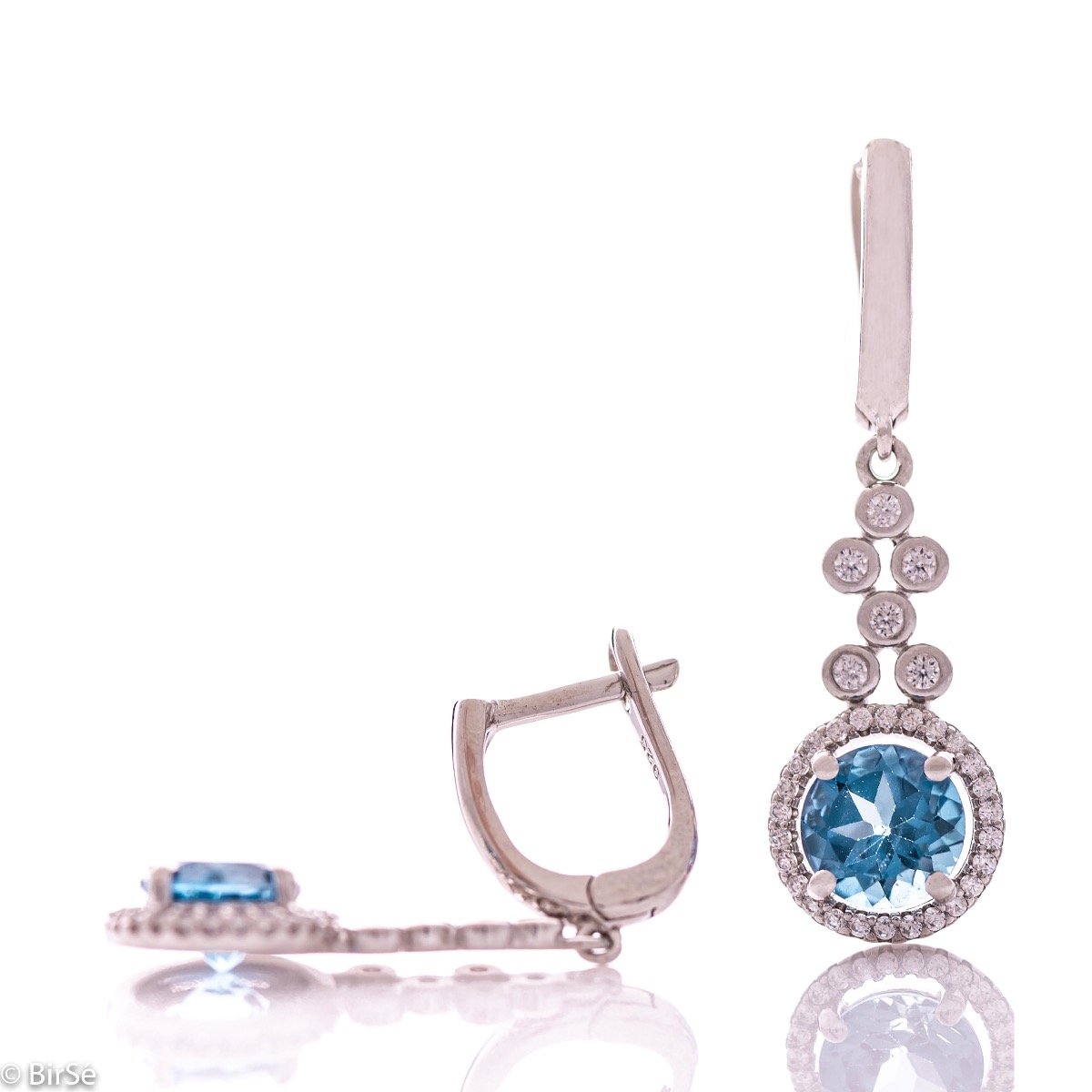 Women's dangle earrings with English clasp and precision craftsmanship in all rhodium-plated silver, combined with radiant natural London topaz and sparkling zircons. They can be combined with a ring and pendant of the same model.