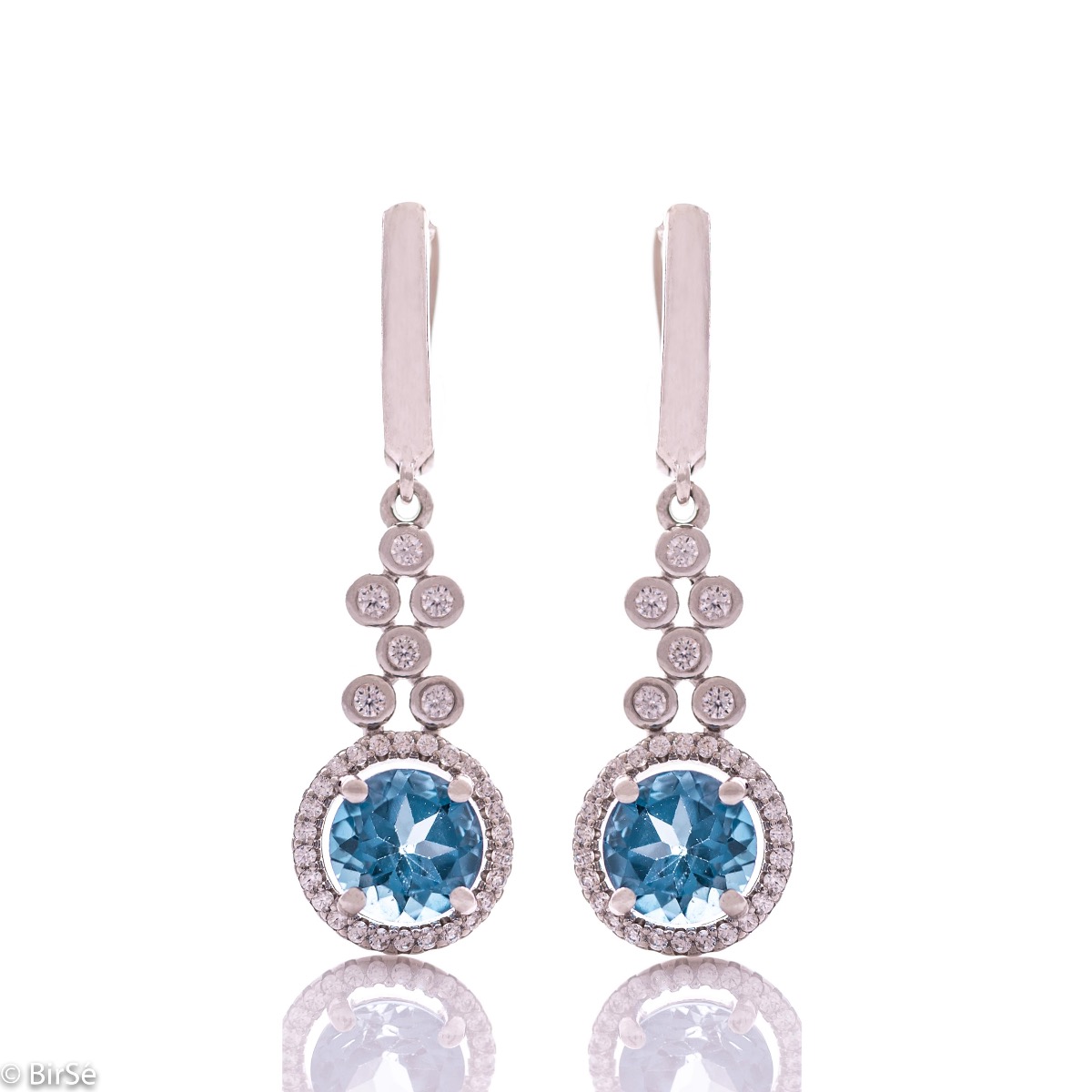 Women's dangle earrings with English clasp and precision craftsmanship in all rhodium-plated silver, combined with radiant natural London topaz and sparkling zircons. They can be combined with a ring and pendant of the same model.