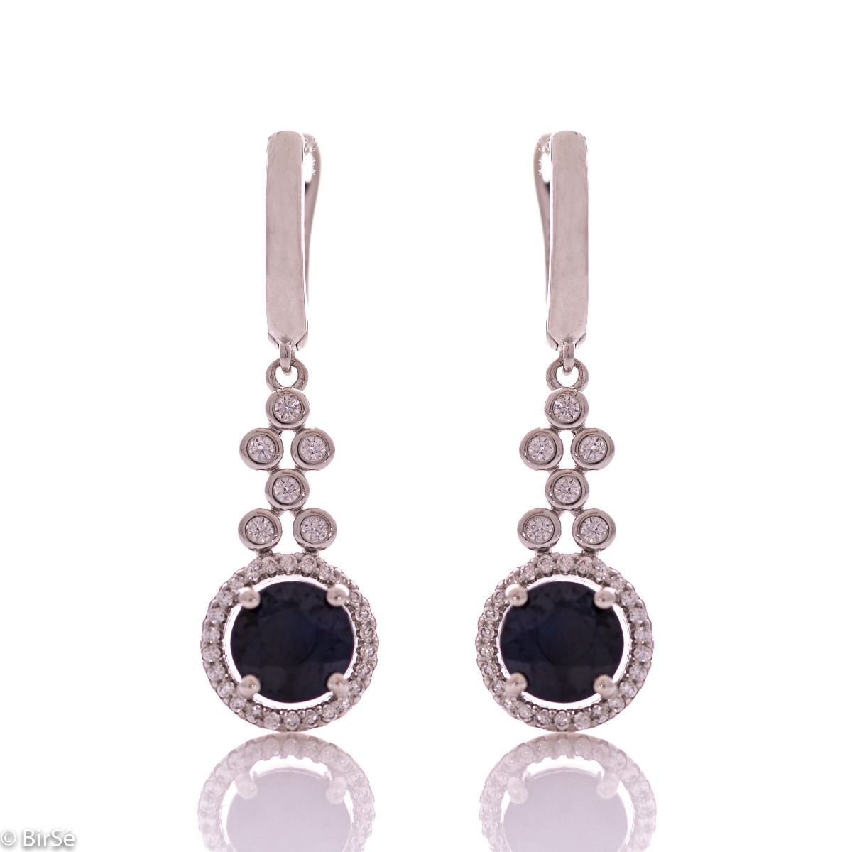 Women's dangling earrings with English clasp and precision craftsmanship entirely in rhodium-plated silver, combined with radiant natural sapphire and sparkling zircons. They can be combined with a ring and pendant of the same model.